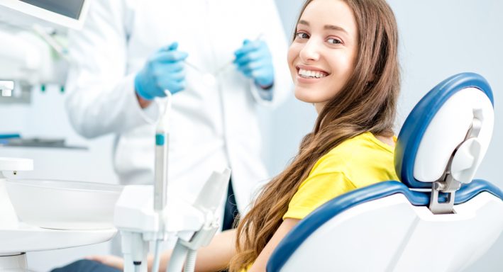 Portrait,Of,A,Woman,With,Toothy,Smile,Sitting,At,The